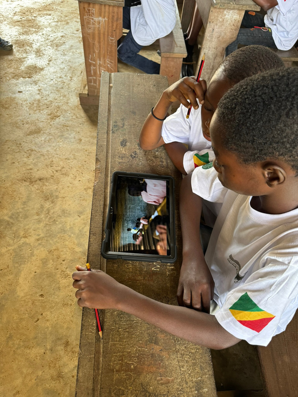 Students working with a conservation education tablet